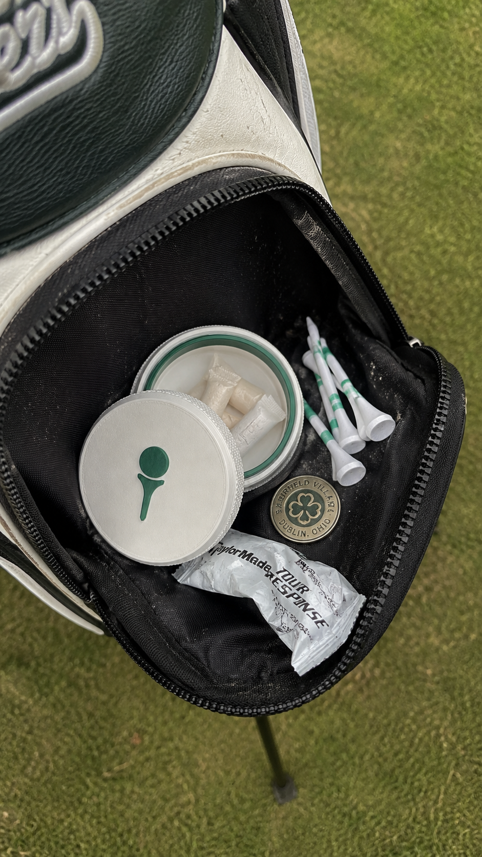 The Tee Box tin in a golf bag pocket with tees